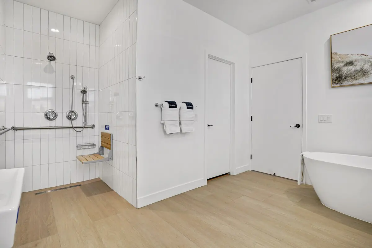 Indio Access Roll-In Shower ADA Roll-in shower with fold-down seat and grab bars at Indio Access wheelchair accessible rental near Acrisure Arena