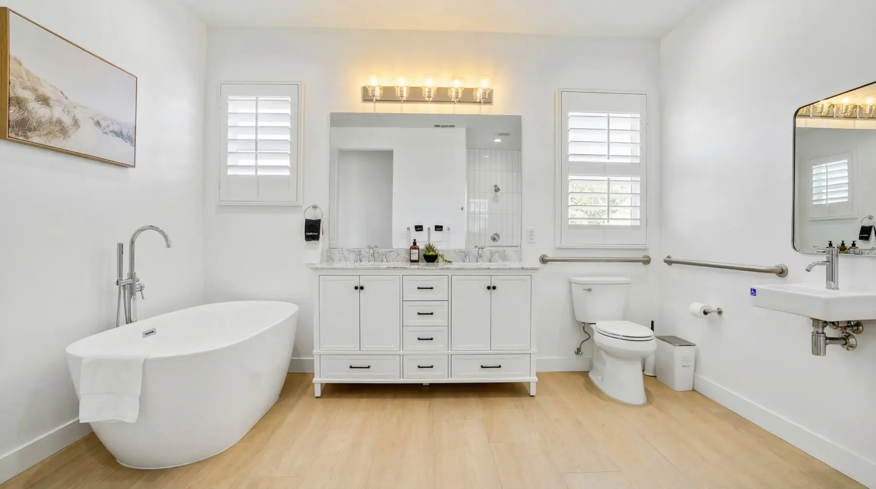 ADA accessible bathroom with grab bars, freestanding soaking tub and open floor plan at Indio Access vacation rental in California