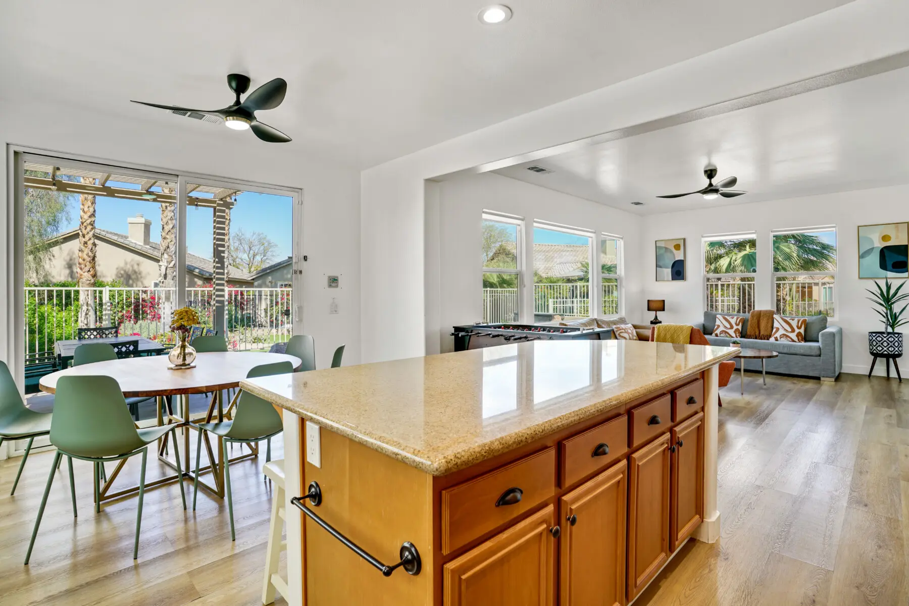 Open plan kitchen and dining room at family vacation rental in Indio CA with backyard view