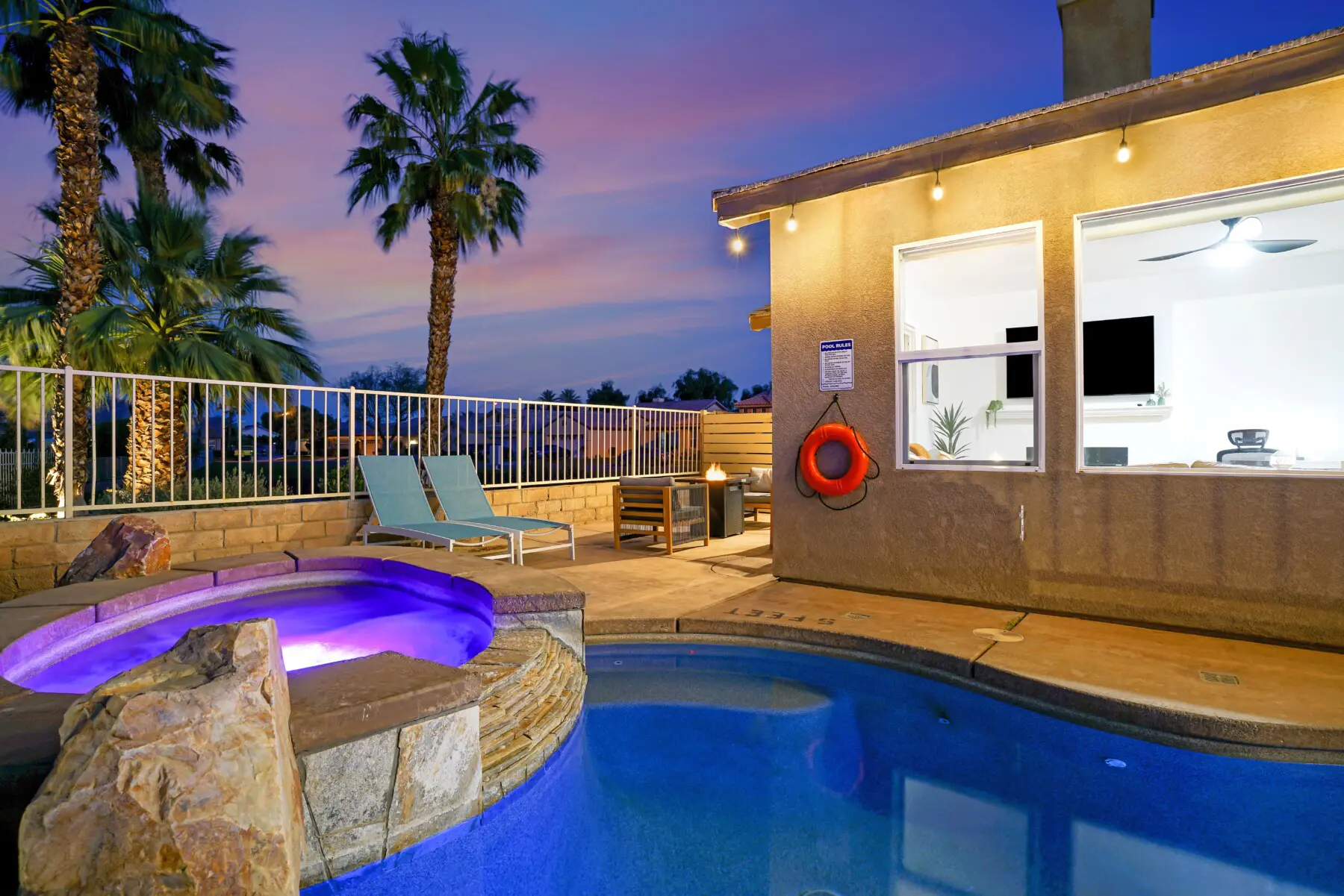 Pool and spa at dusk at Joshua Tree day trip vacation rental in Indio CA