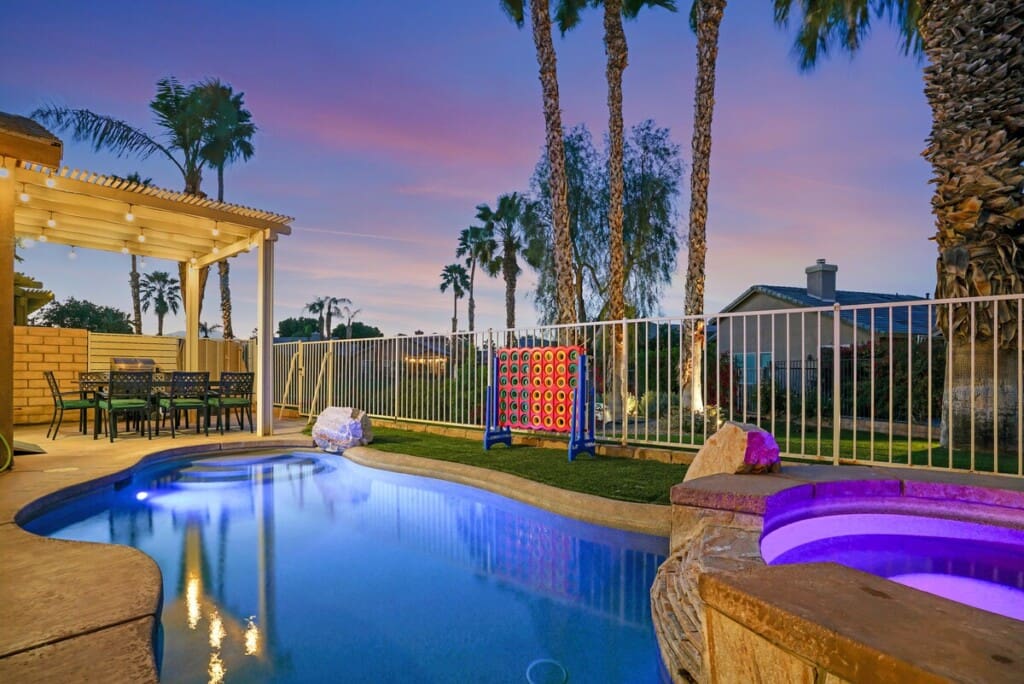 Private heated saltwater pool at night — Indio Access wheelchair accessible vacation rental near Acrisure Arena