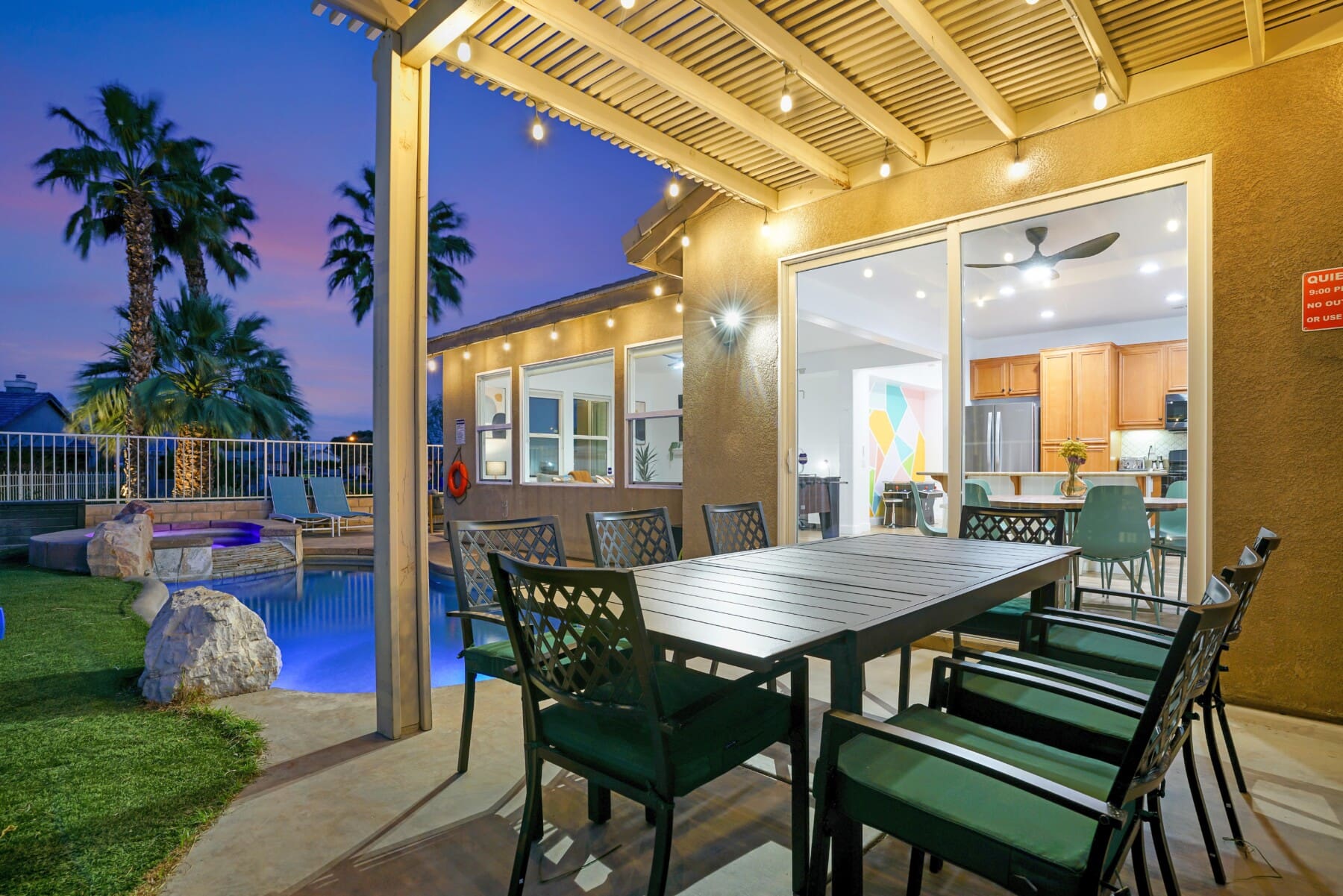 Backyard pool and spa at dusk at Palm Springs weekend rental home in Indio CA