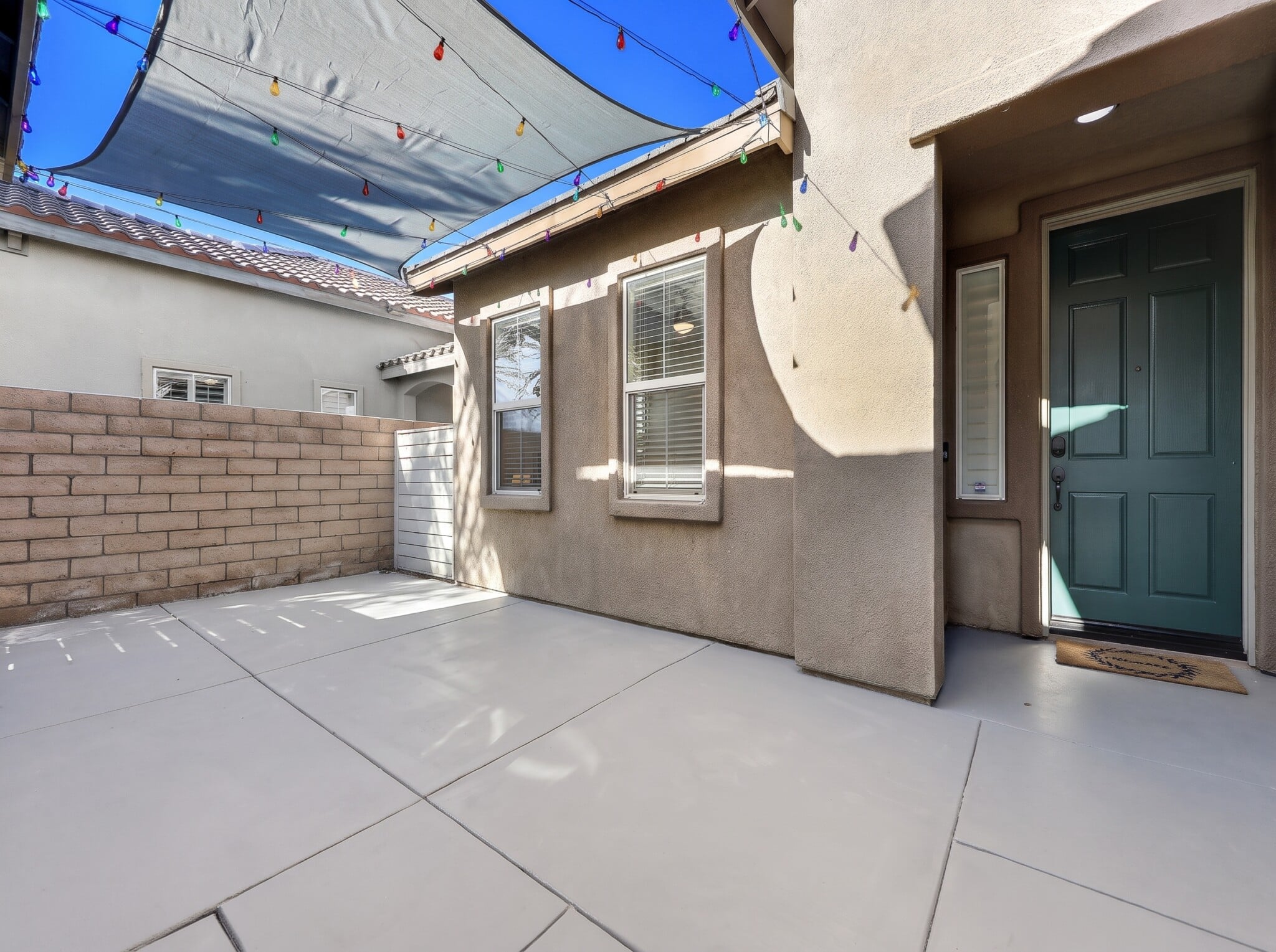 Step-free entry with flat path to 36 inch front door at roll-in shower vacation rental in Indio